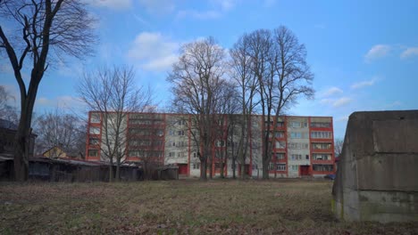 exterior of former soviet apartment block in winter with grey concrete foreground