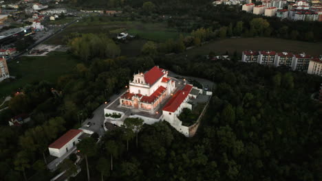 top exterior facade of our lady of incarnation chapel, with foliage landscape in leiria, portugal