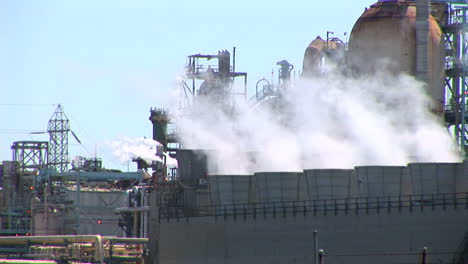 steam rises from evaporative stacks at a power facility