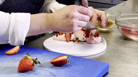 pouring rose petals above a strawberry dessert