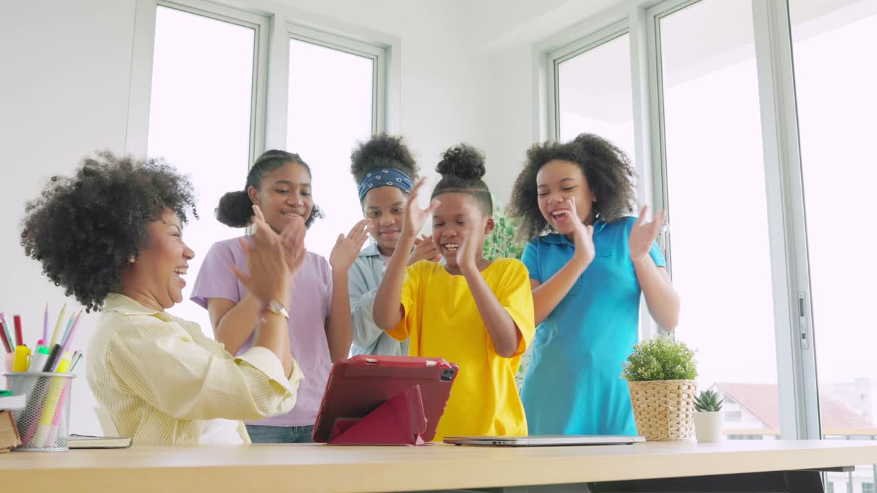 African American teachers congratulate children with a round of applause