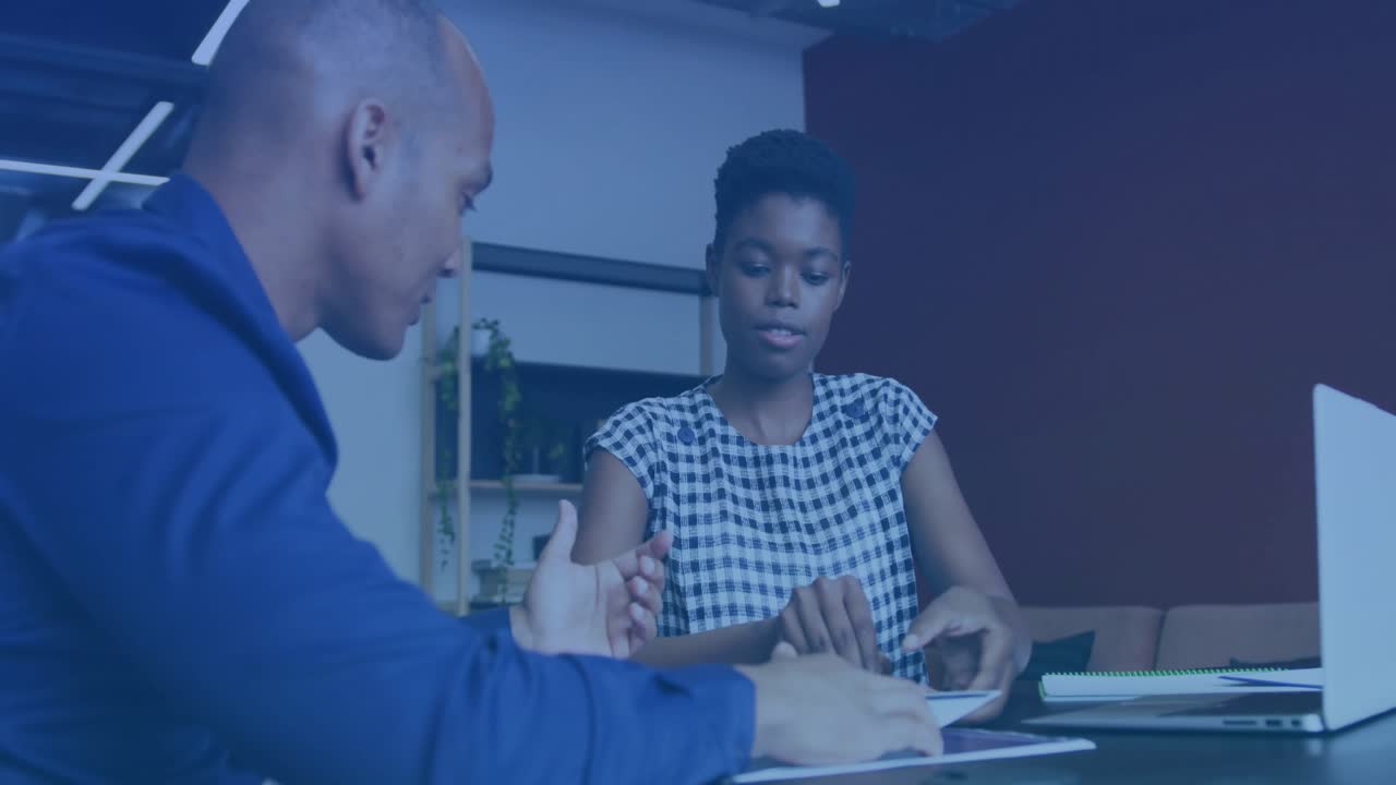 Man sliding printed report toward woman analyzing charts while financial data overlays appearing