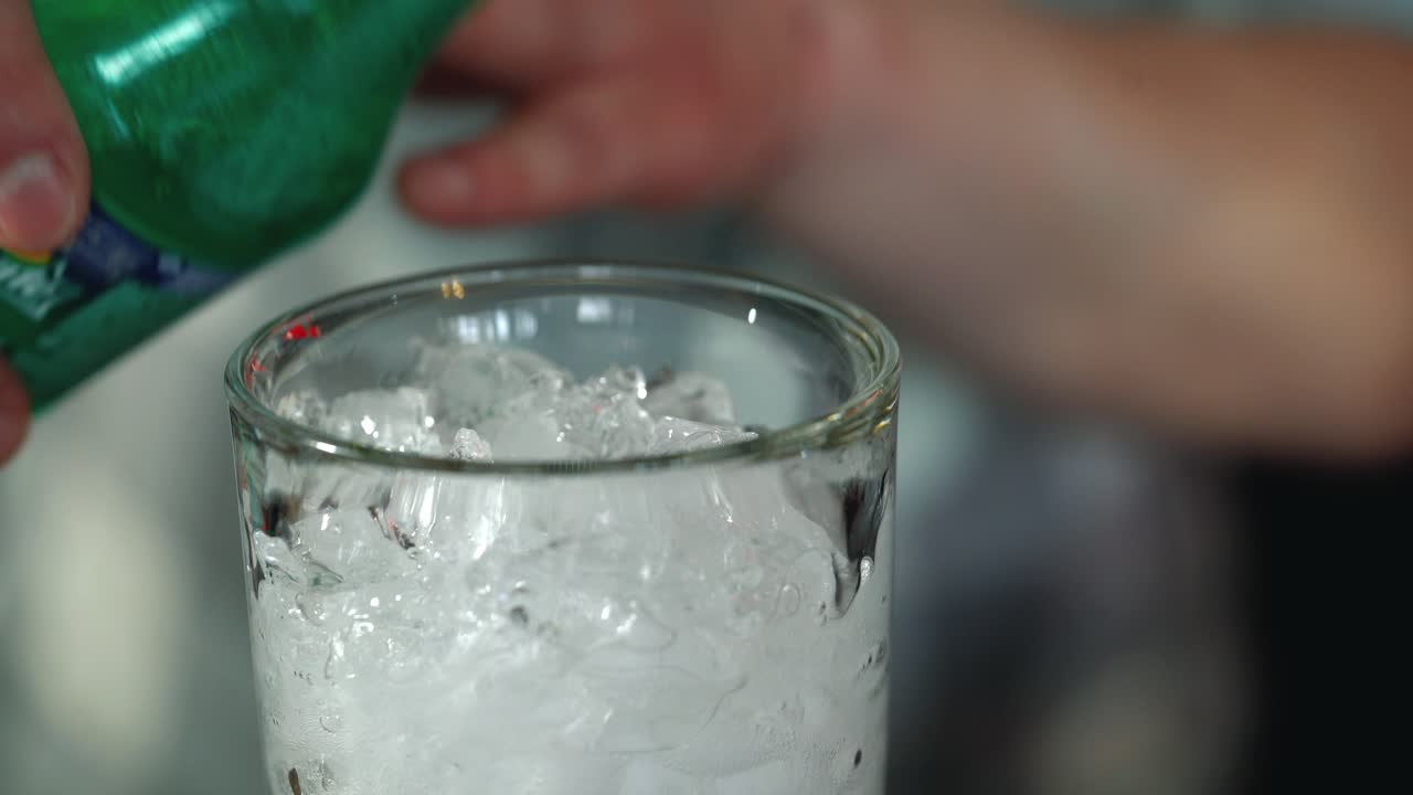 Barman makes a cocktail over the bar counter. Process of preparing a non-alcoholic cocktail.