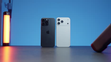 two smartphones on a blue background with led lighting