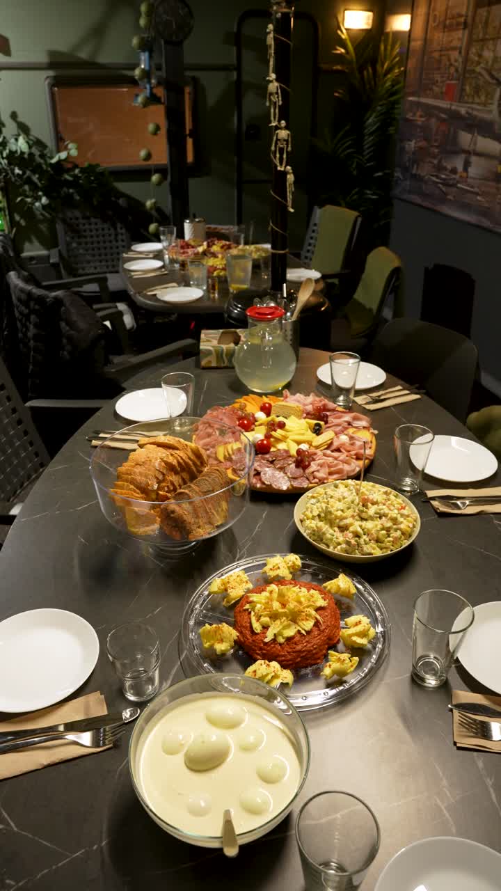 Vertical 9:16 video of a Christmas dinner featuring gourmet steak tartare, artisan cheese platter, and traditional salad for a festive holiday celebration