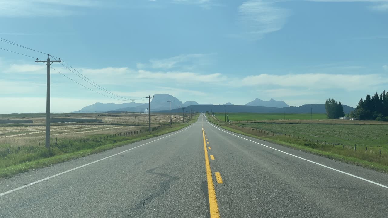 Road towards the mountains POV, Alberta Canada