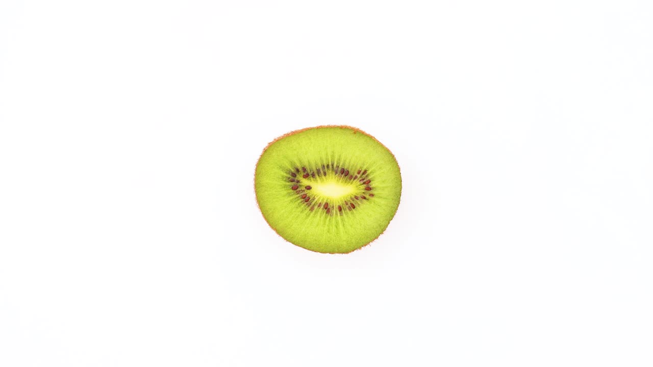 Sliced fresh kiwi rotating on white background - Stop motion