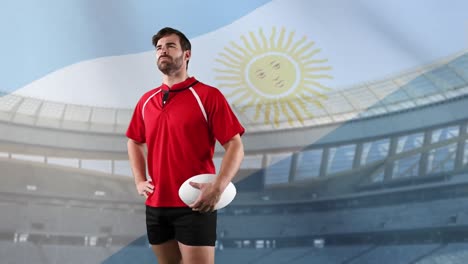 professional rugby player standing in front of a flag and stadium