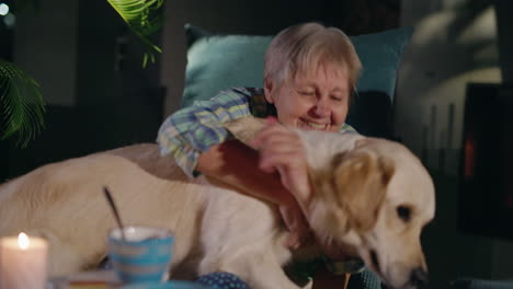 senior woman and golden retriever enjoying a cozy evening