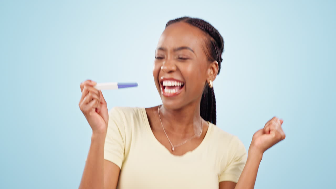 Happy, excited and woman with pregnancy test