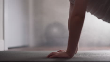 determined boy does push ups falling and lifting body up