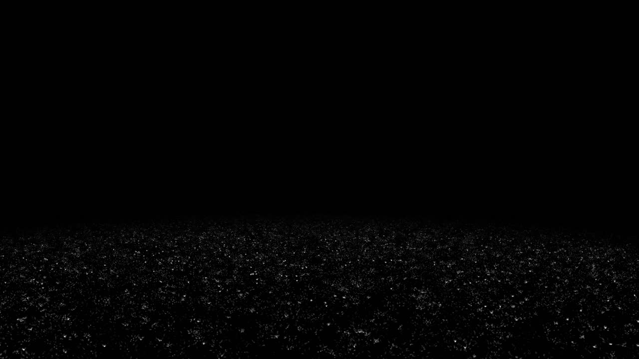 Heavy raindrops hitting a dark, reflective floor surface on a black background. Seamless loop for intense weather effects, dramatic overlays, or atmospheric backgrounds