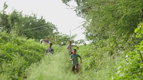children running through a green field