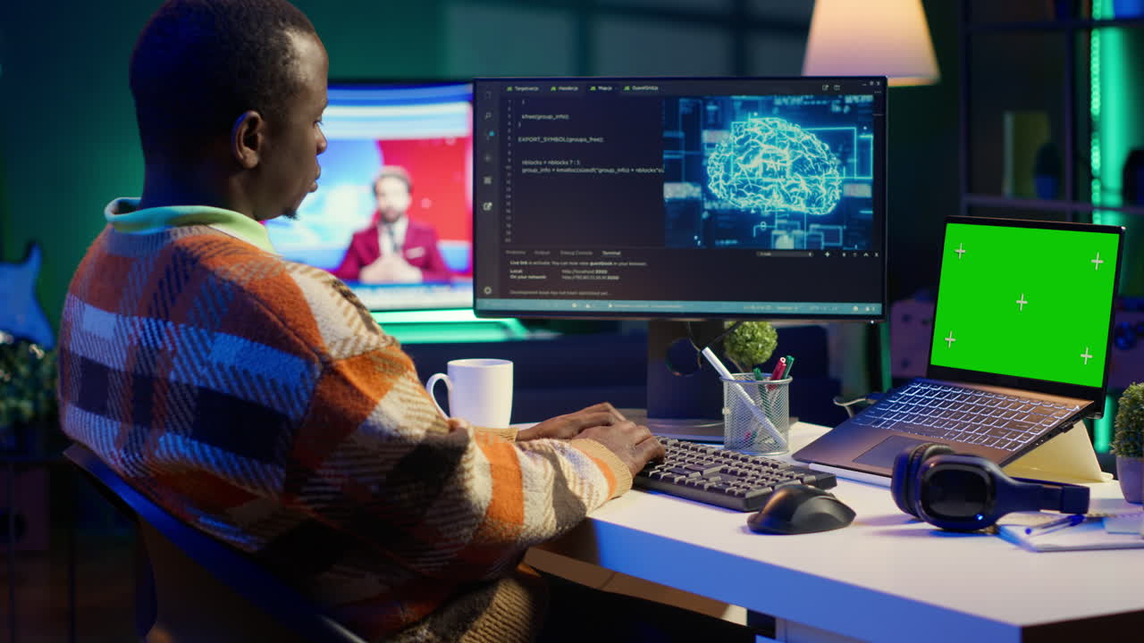 Man coding with AI interface on computer with green screen