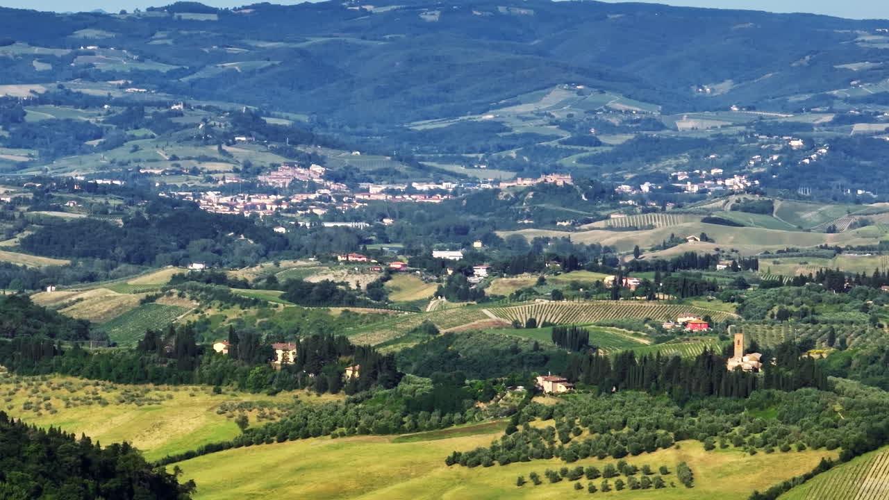 Telephoto drone shot of homes on the idyllic countryside of Tuscany, Italy
