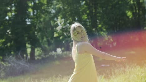 woman in yellow dress dancing gracefully in summer park