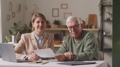 portrait of cheerful financial agent and senior man