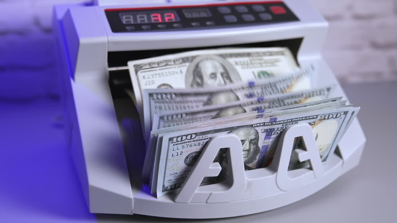 Bank cash counter machine with a stack of dollars. Horizontal view of the finance business money counting. Money and business concept