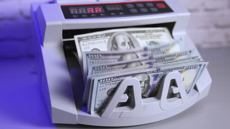 bank cash counter machine with a stack of dollars. horizontal view of the finance business money counting. money and business concept
