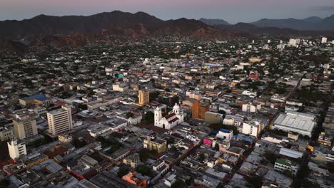 Aerial-view-circling-over-the-skyline-of-Santa-Marta,-sunny-morning-in-Colombia