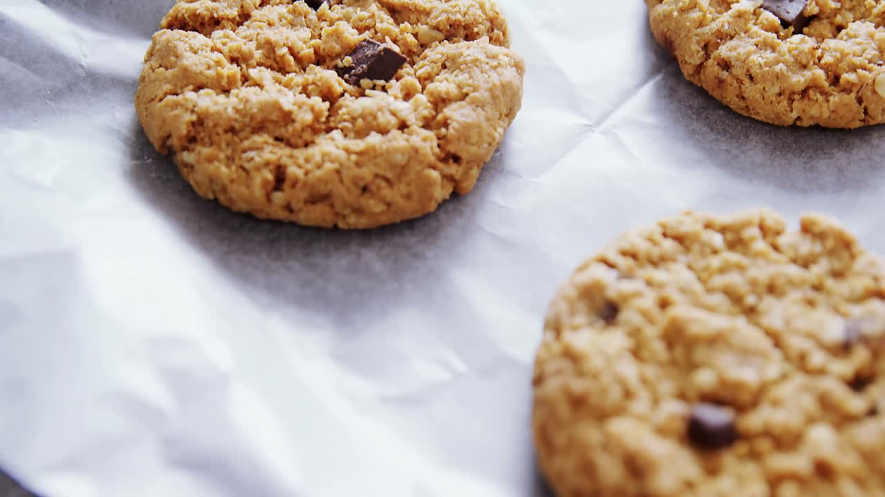 Freshly baked cookies on wax paper 4k