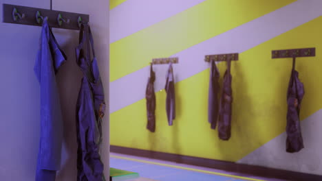 colorful wall with hanging garments in a small creative space for activities