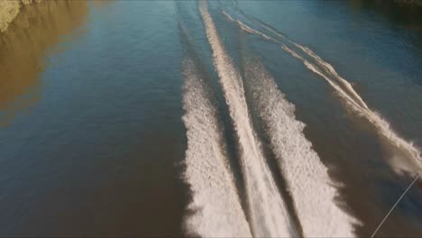 drone flying over the waterski on the river