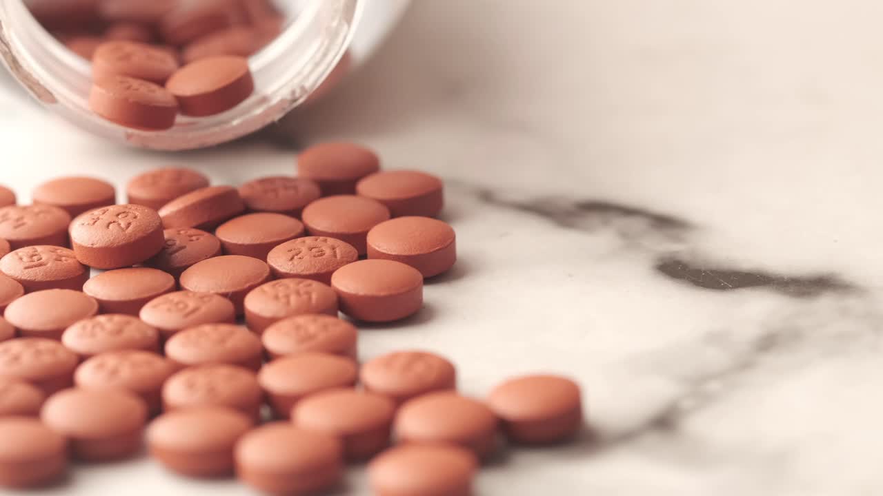 Brown Pills on Marble Surface