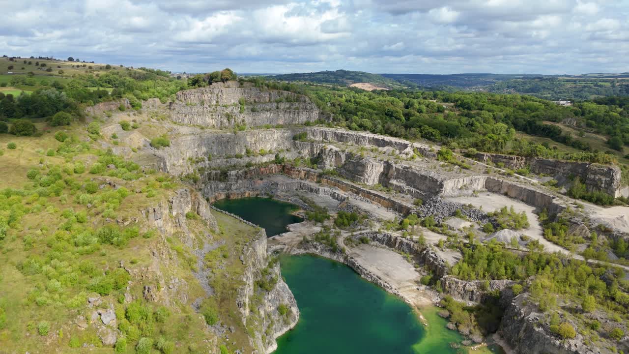 Elevated drone capture showing old mining quarry and rural landscape near Crich in the Derbyshire Dales, England