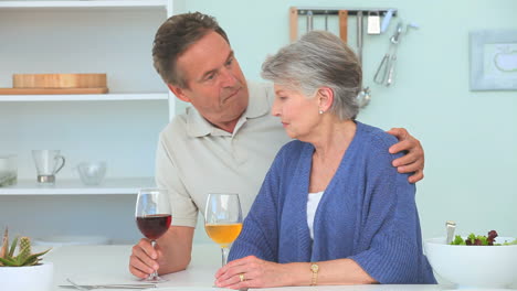 elderly couple drinking wine