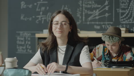 young students in a classroom with a chalkboard full of equations