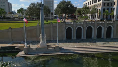 american flags stand tall above lake mirror in the centre of lakeland, florida