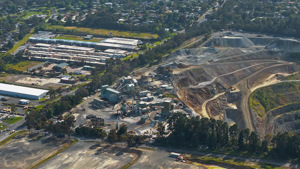 Hyperlapse drone video showcasing the expansive Boral Quarry in Montrose, Melbourne. Captures the industrial landscape with machinery, tiered rock layers, and surrounded greenery under clear skies