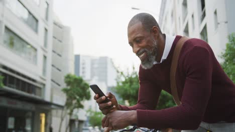 african american man using his phone in the street