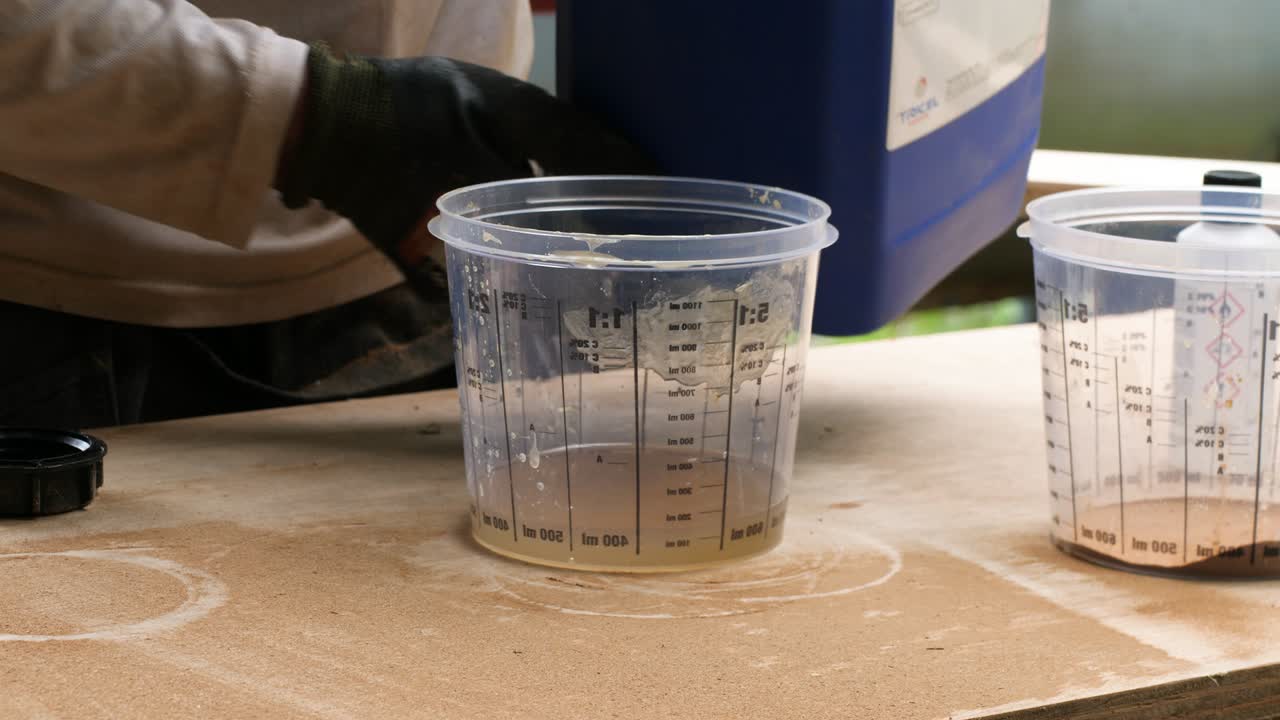 Pouring polyester resin into container