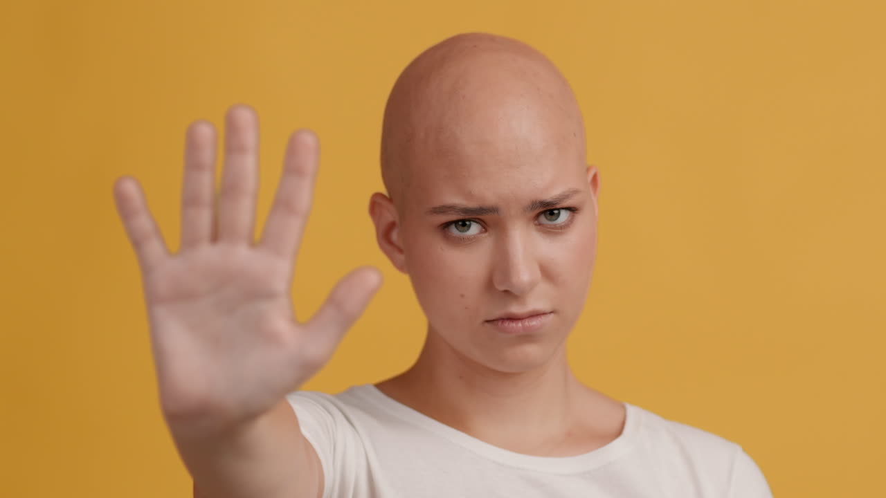 Woman with Alopecia Showing Stop Gesture