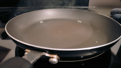 close-up of water evaporating on teflon pan