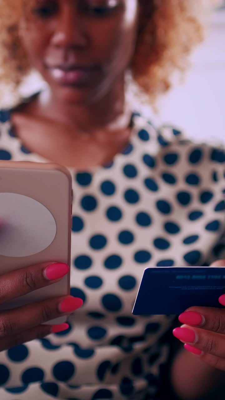 Woman using smartphone and credit card while shopping online