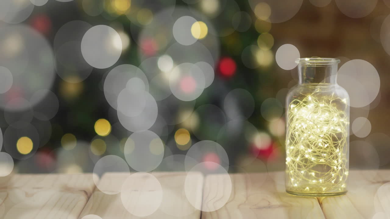 Glowing fairy lights in jar with bokeh lights animation in background