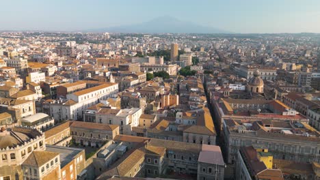 cinematic drone flight above catania city with mt etna in background