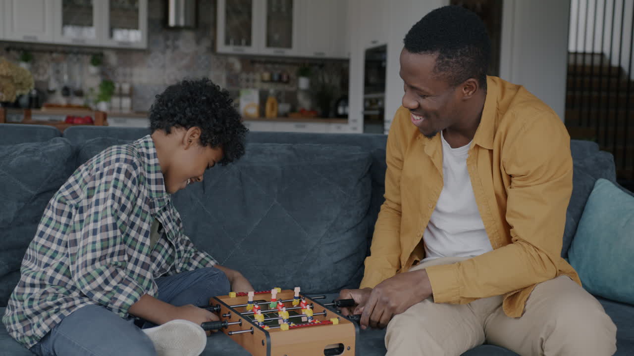 Father and Son Playing Foosball