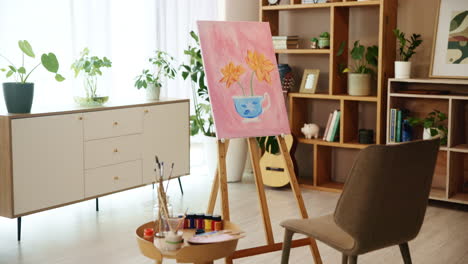 artist's studio with a painting of flowers