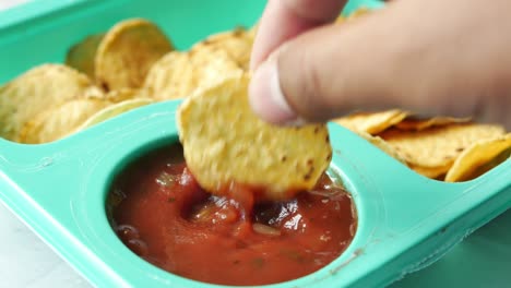 a bowl of chips and salsa on table