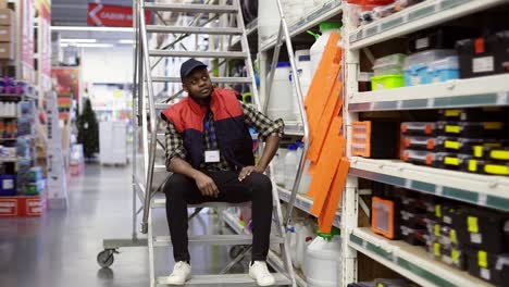 salesman or owner in hardware store, posing to the camera