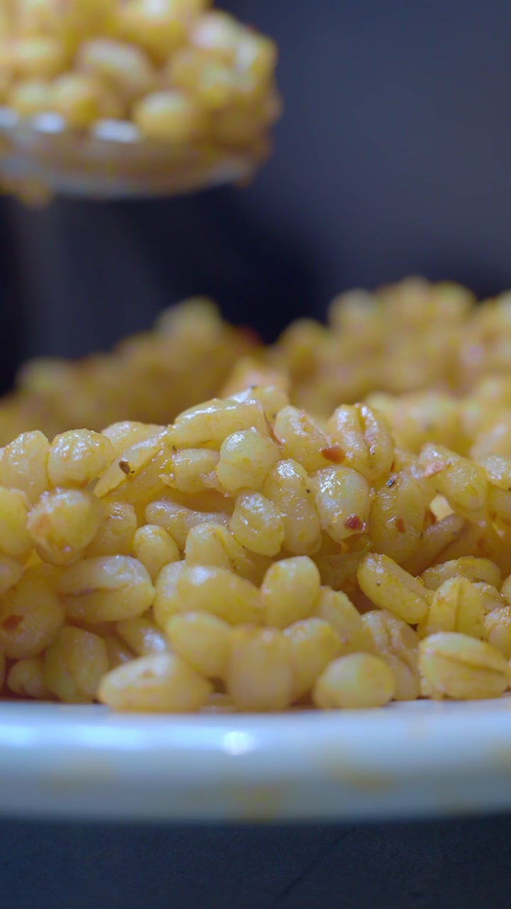 Close-up of Bulgur Grain Being Scooped from a Plate