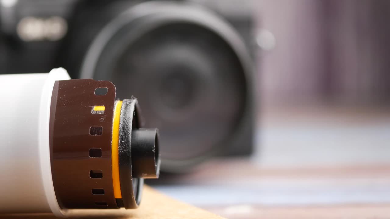 Close-up of a film roll and a camera