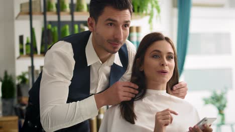 handheld view of customer showing which hairstyle she wants