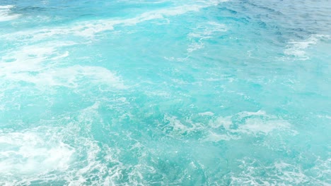 agitated turquoise emerald sea waves with white foam in alcala, tenerife