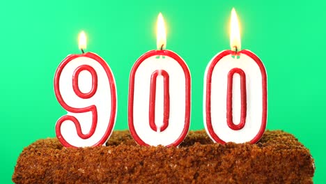 cake with the number 900 lighted candle. chroma key. green screen. isolated