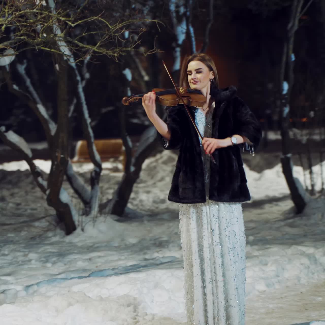 Artist playing violin at night